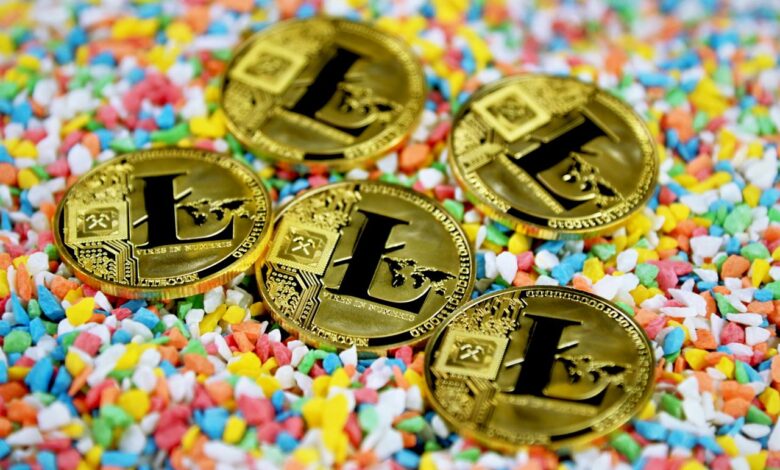 gold round coin on multicolored textile