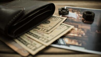 black leather bifold wallet on banknotes